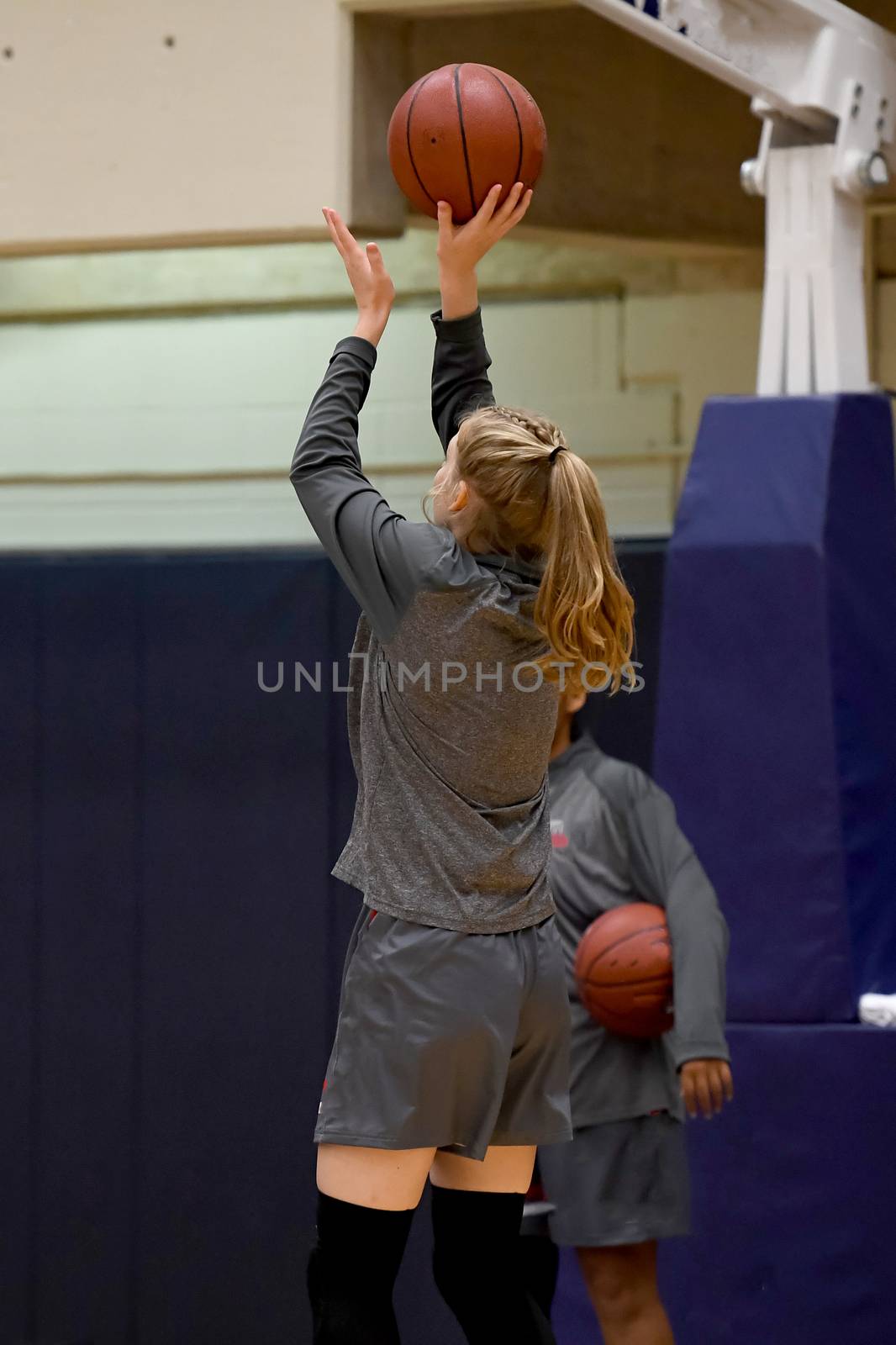 Exciting plays being made by young girls playing basketball