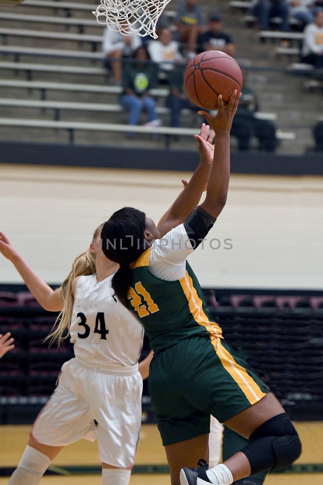 Exciting plays being made by young girls playing basketball