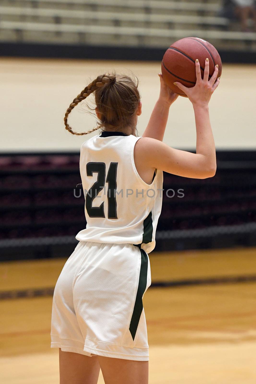 Exciting plays being made by young girls playing basketball