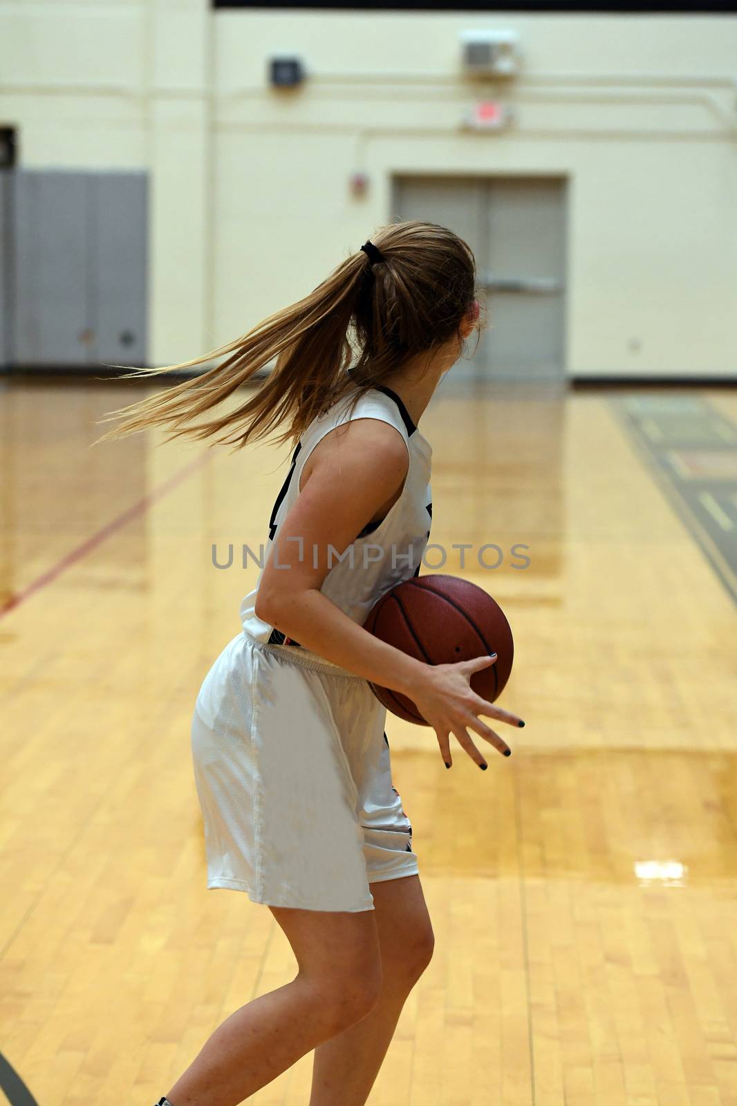 Exciting plays being made by young girls playing basketball