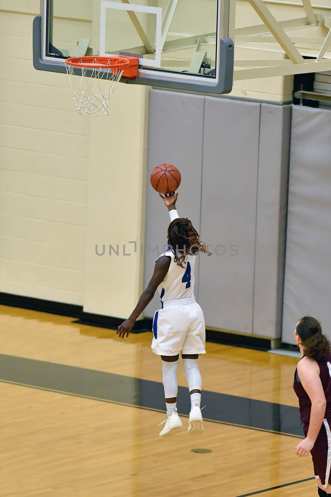 Exciting plays being made by young girls playing basketball