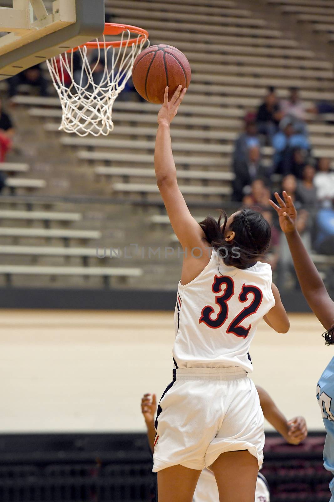 Exciting plays being made by young girls playing basketball