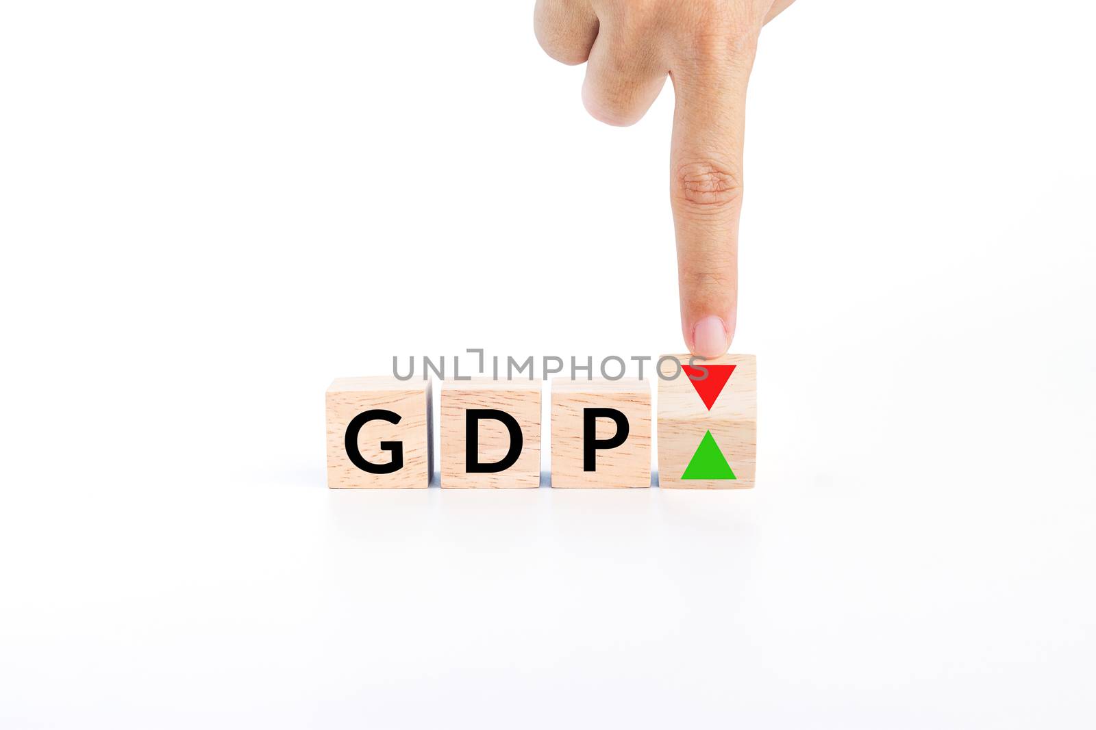 hand flip wooden cube to changes the direction of an arrow symbolizing that the GDP (gross domestic product) of a country is changing the trend and growth up instead of down