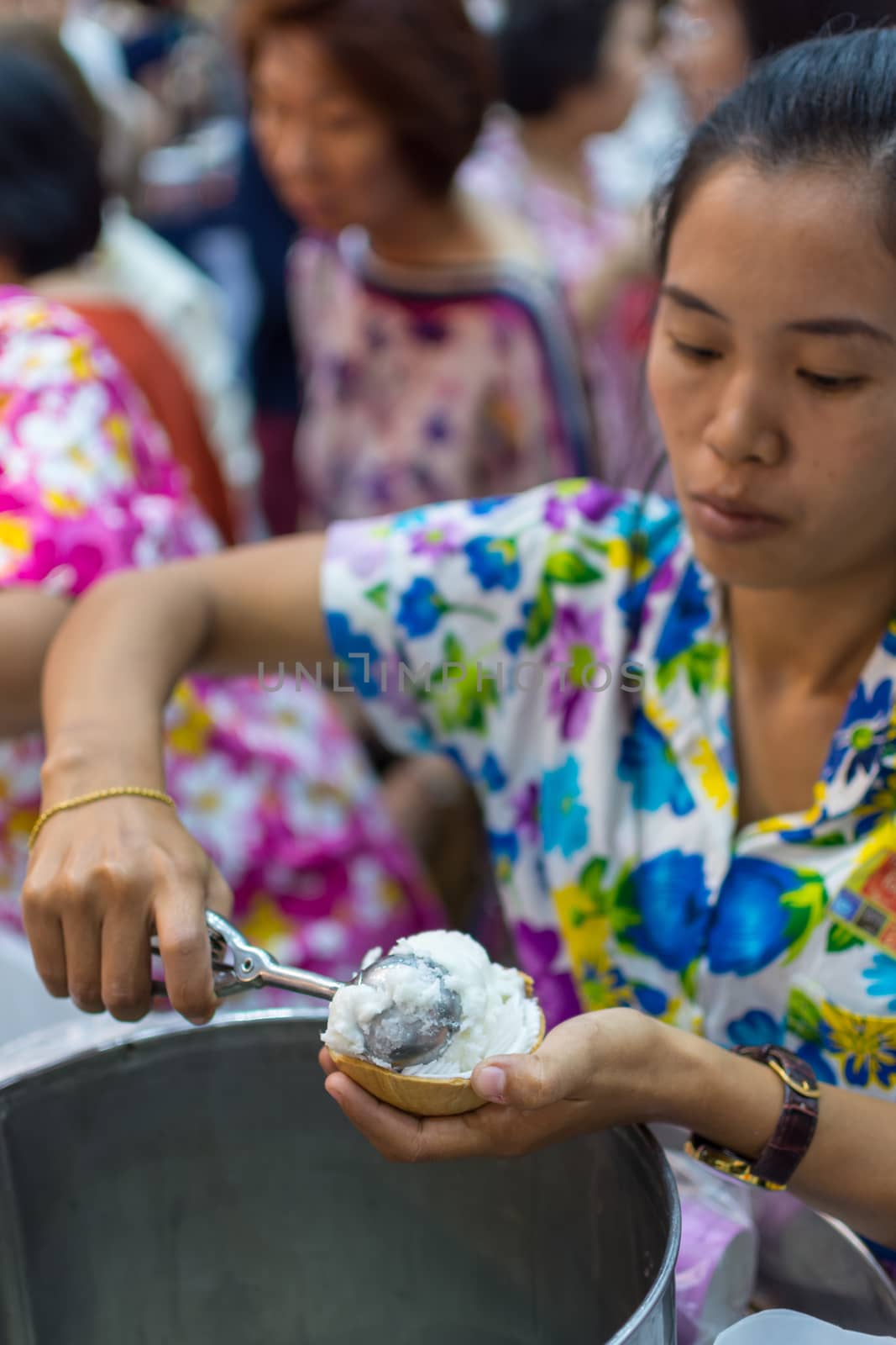 Women serving icecream coconut milk by PongMoji