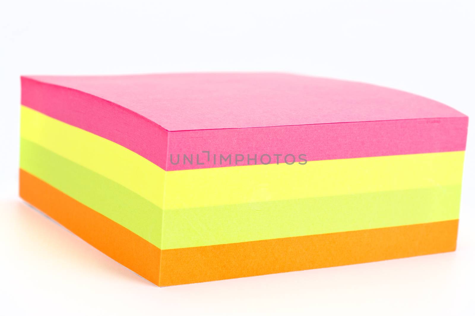 Multi colored sticky note isolated on white background.