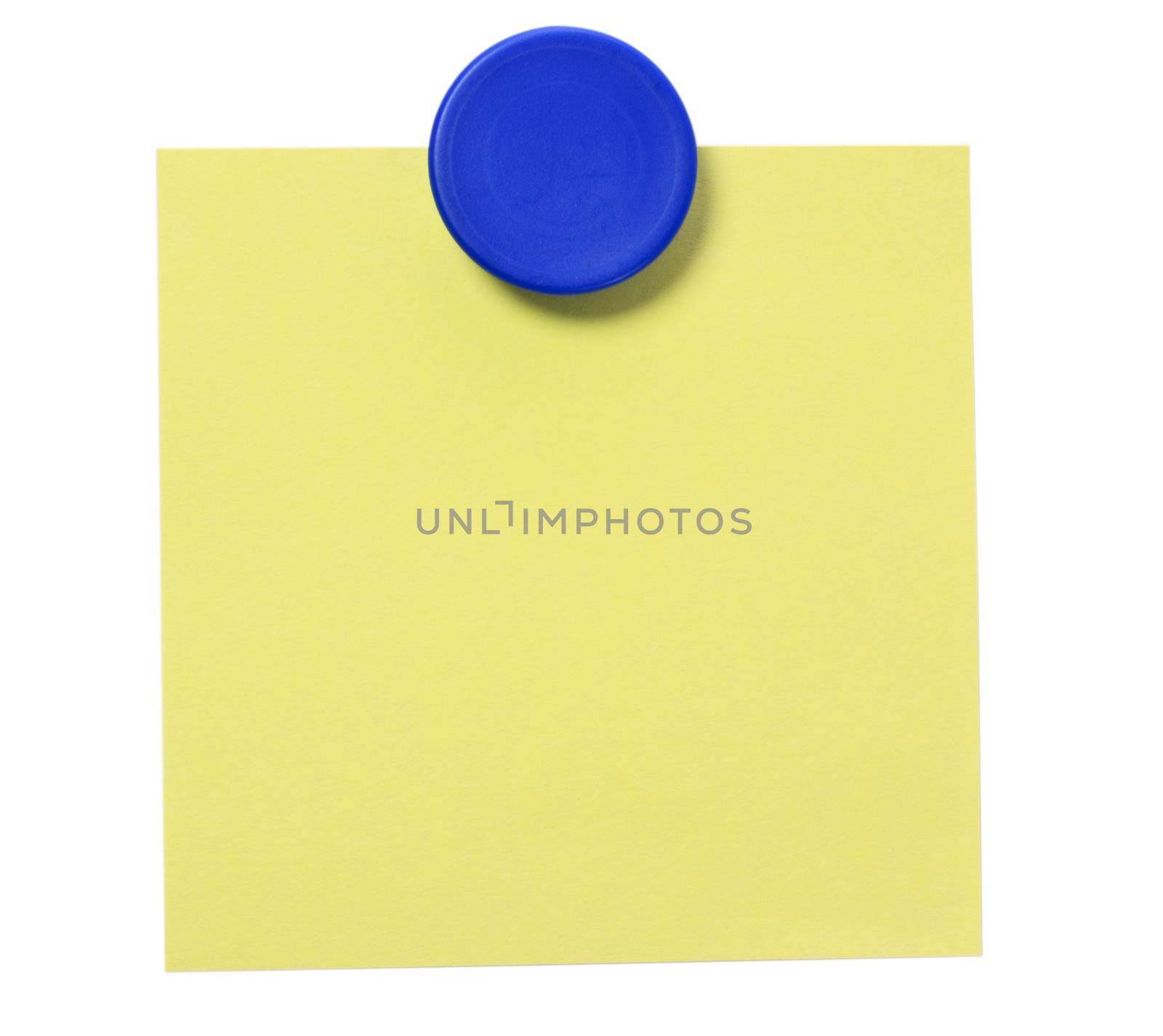 Yellow adhesive note and blue magnet button on whiteboard.