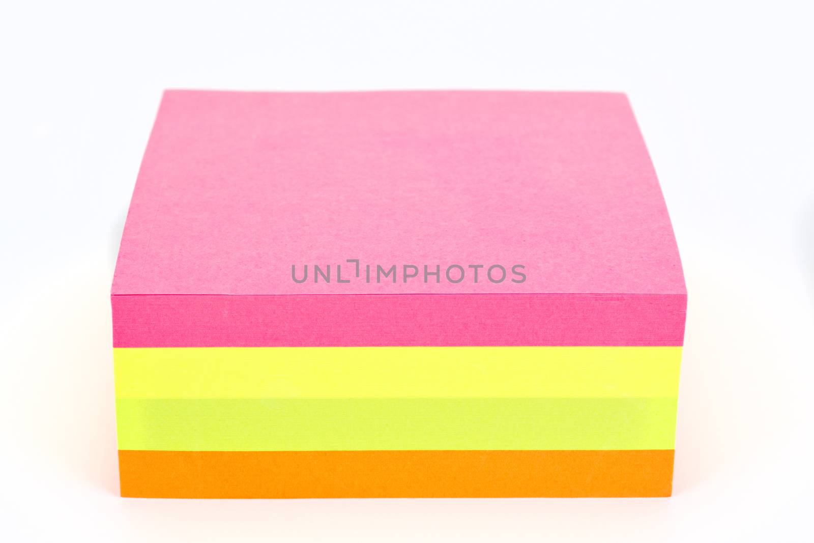 Multi colored sticky note isolated on white background.