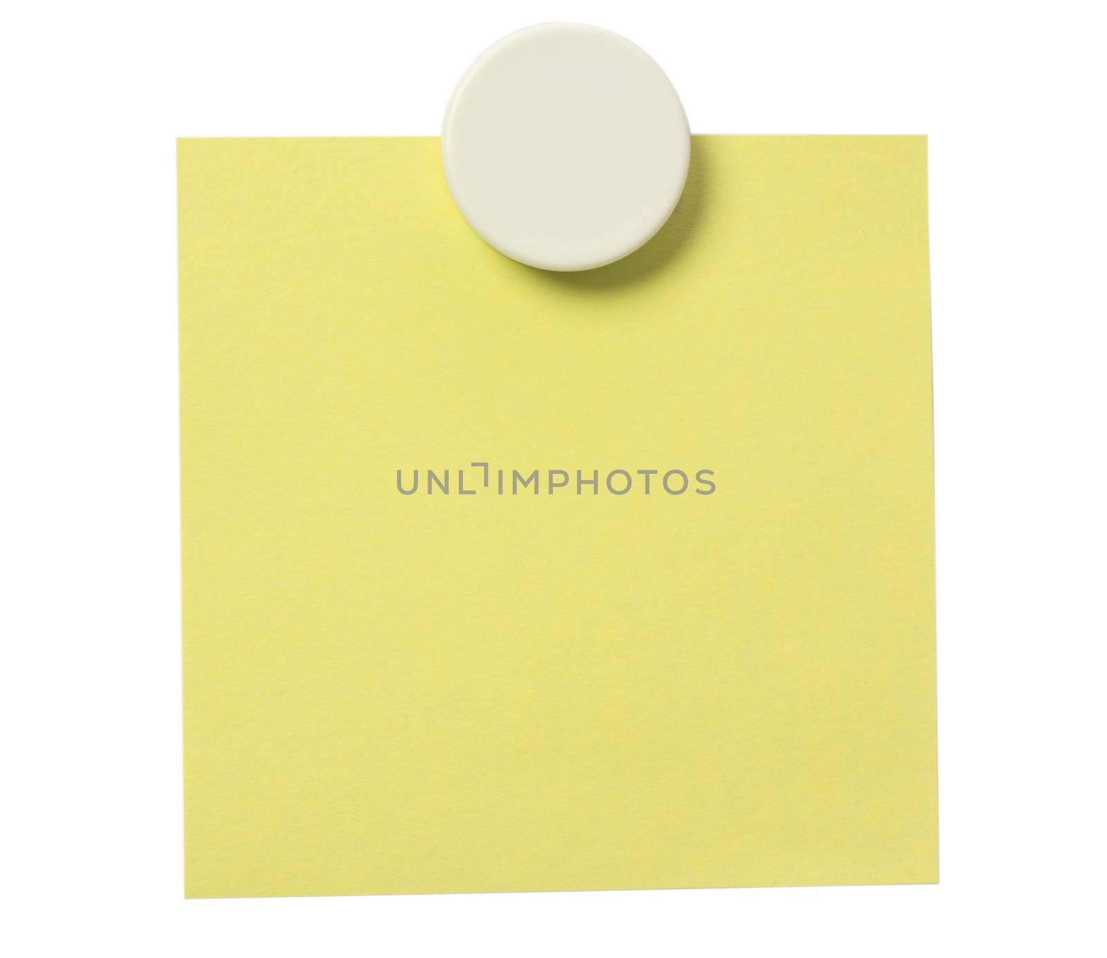 Yellow adhesive note and white magnet button on whiteboard.