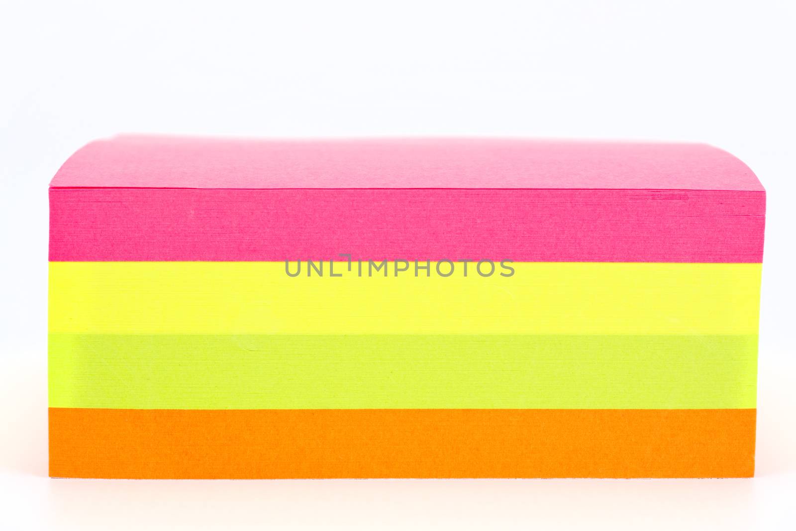 Multi colored sticky note isolated on white background.