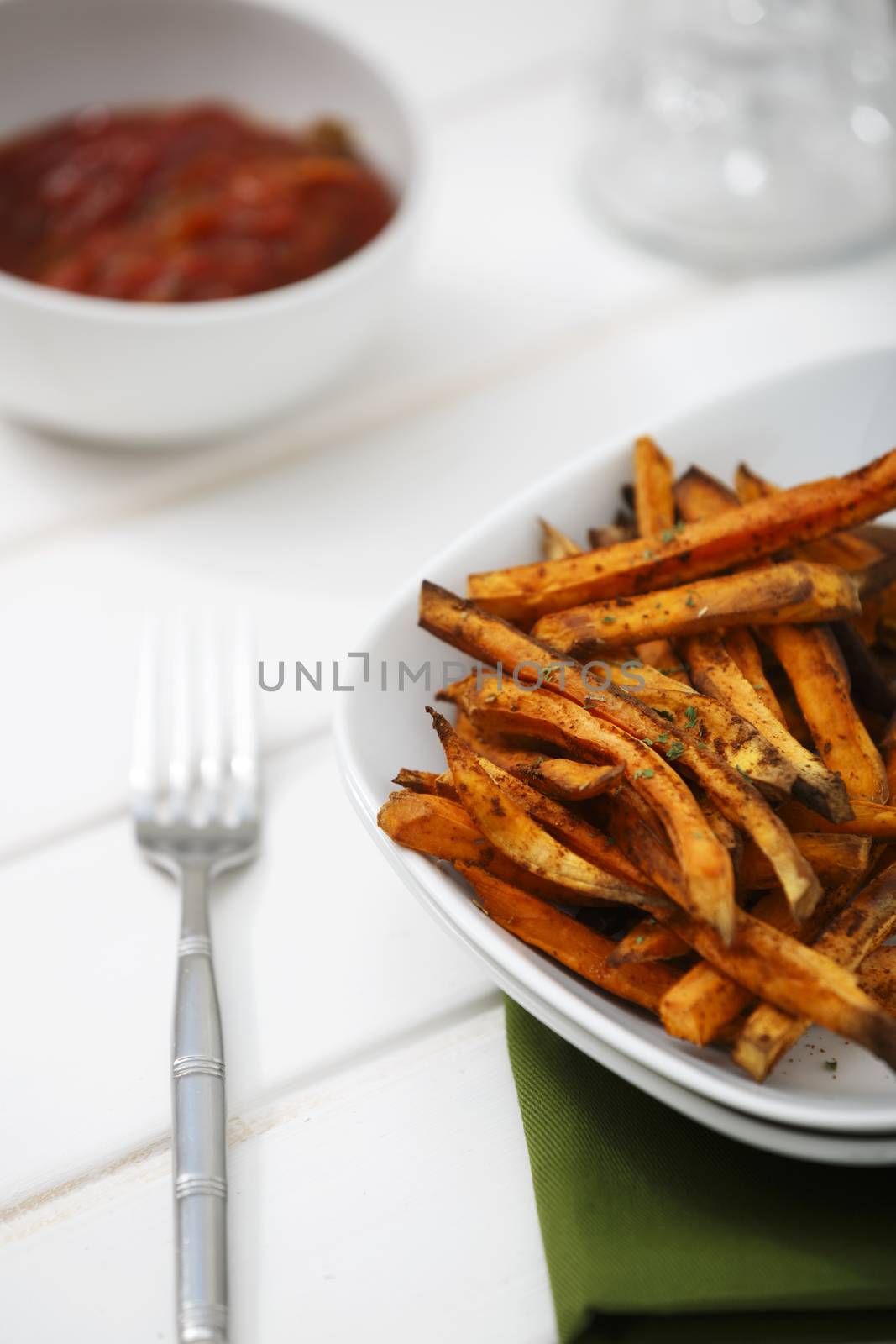 Sweet potato baked salted with paprika pepper with hot tomato sauce.