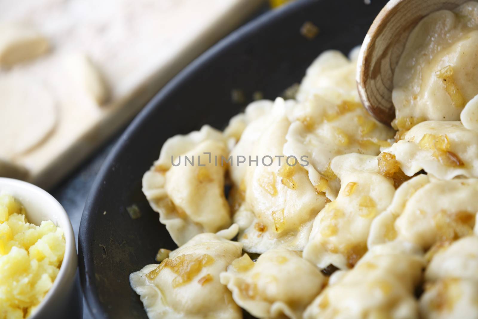 Pierogi fried with potato mash.