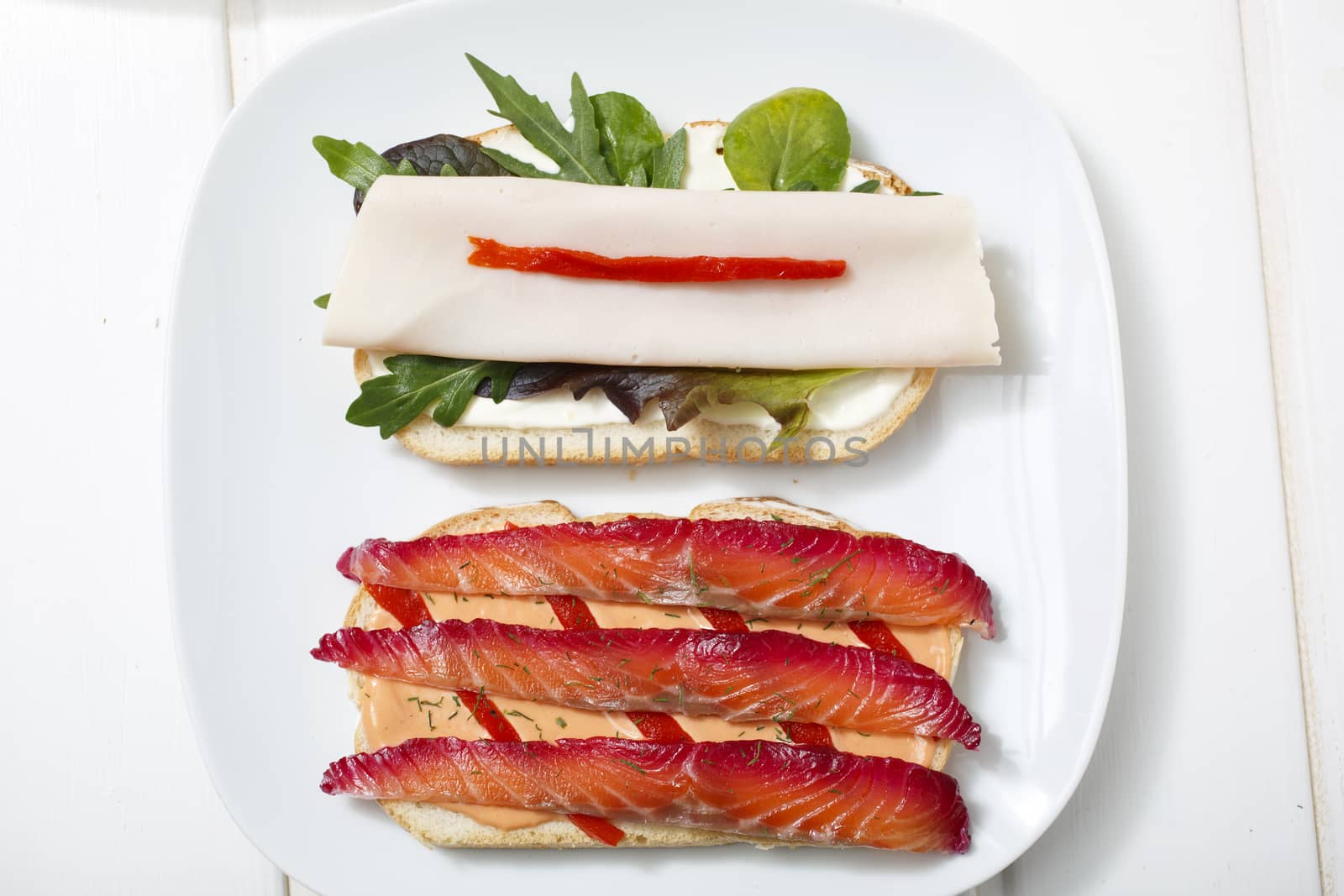 Delicious sandwich with gravlax, turkey and green vegetables.