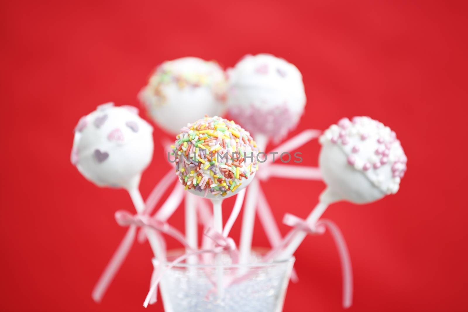 Cakepop over red background.