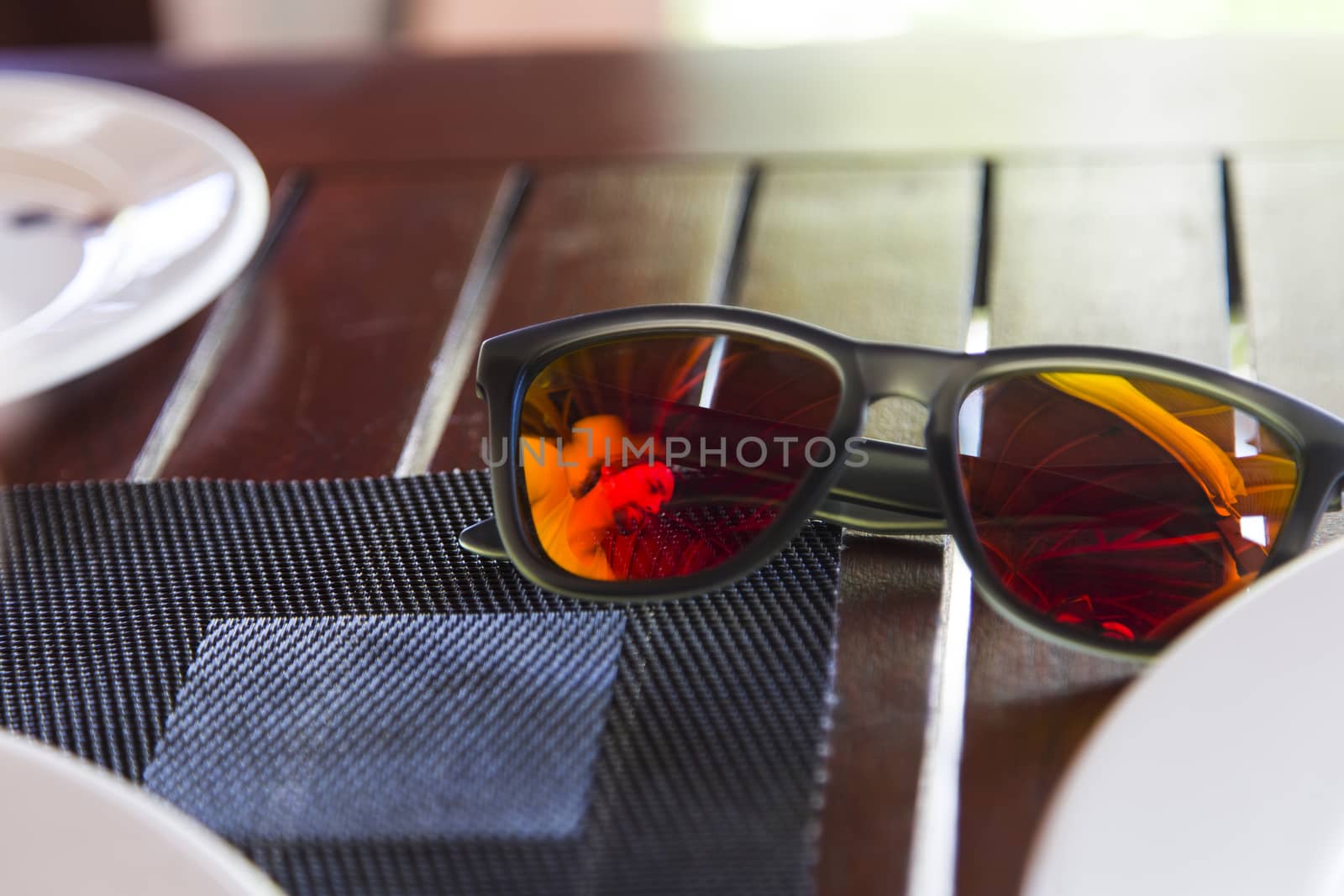 Reflection of a Man on Sunglasses over a Table during Breakfast. by Nemida