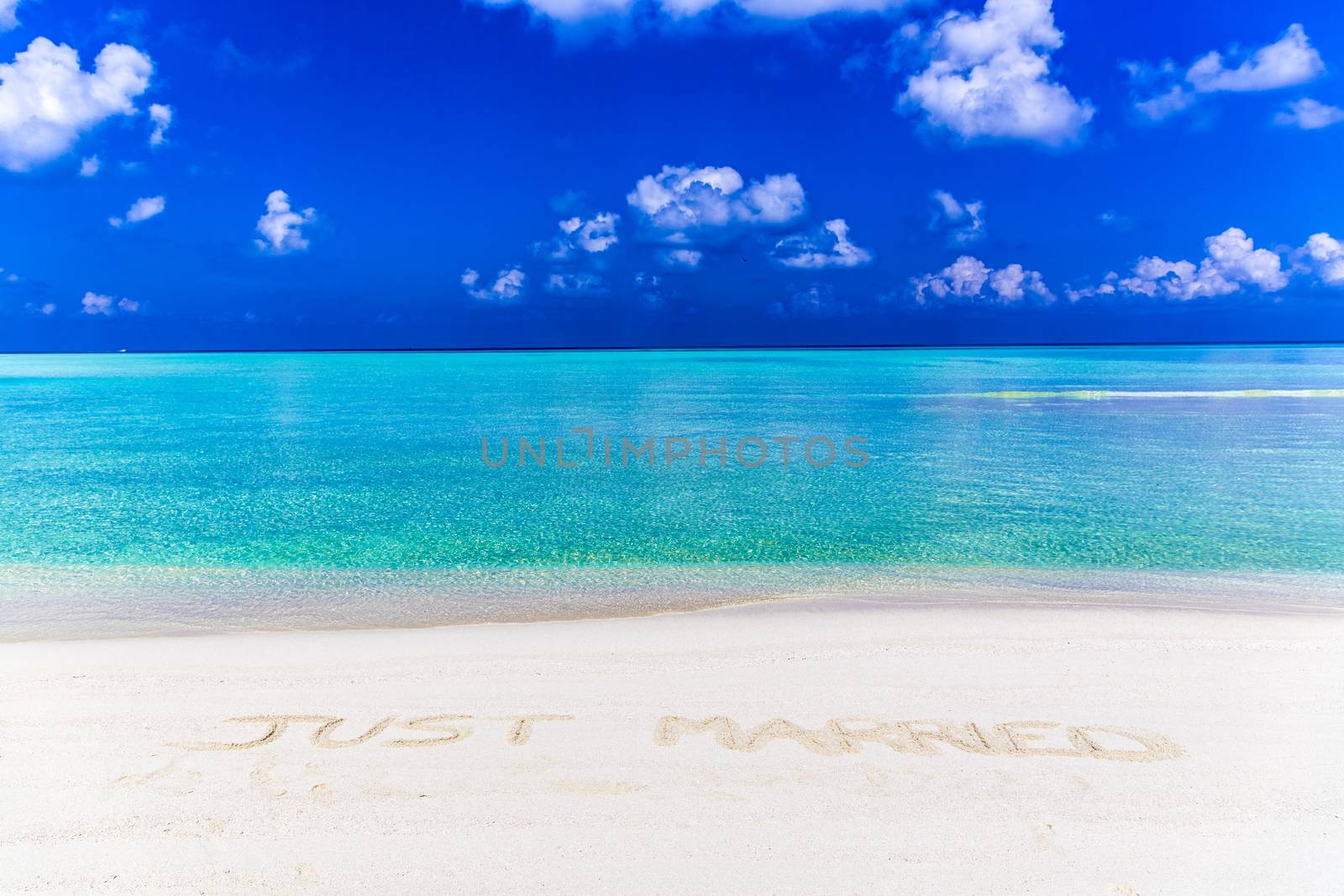 Message of just married written on sand in Maldives.