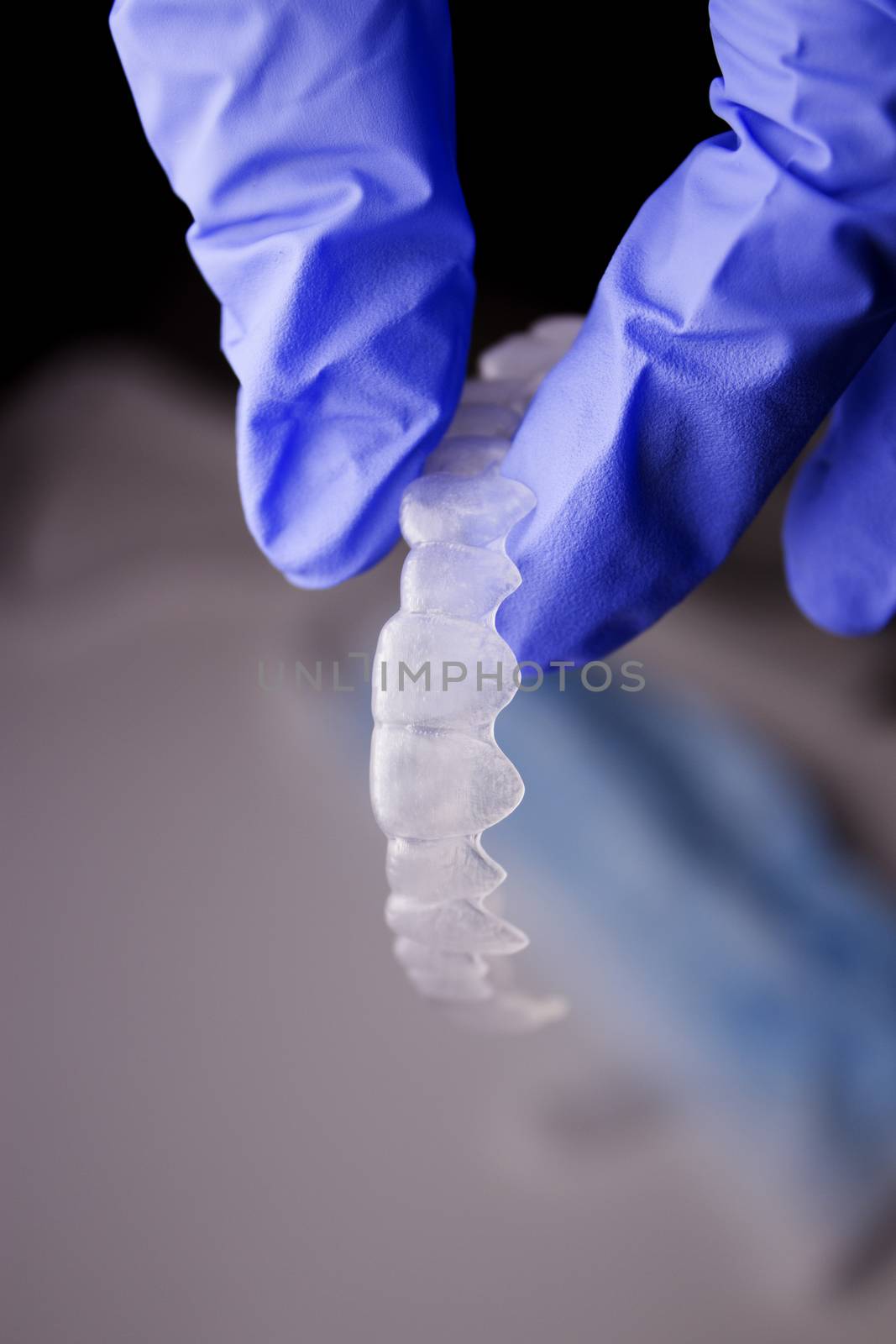 Dentists hand with latex gloves holding a dental orthodontic