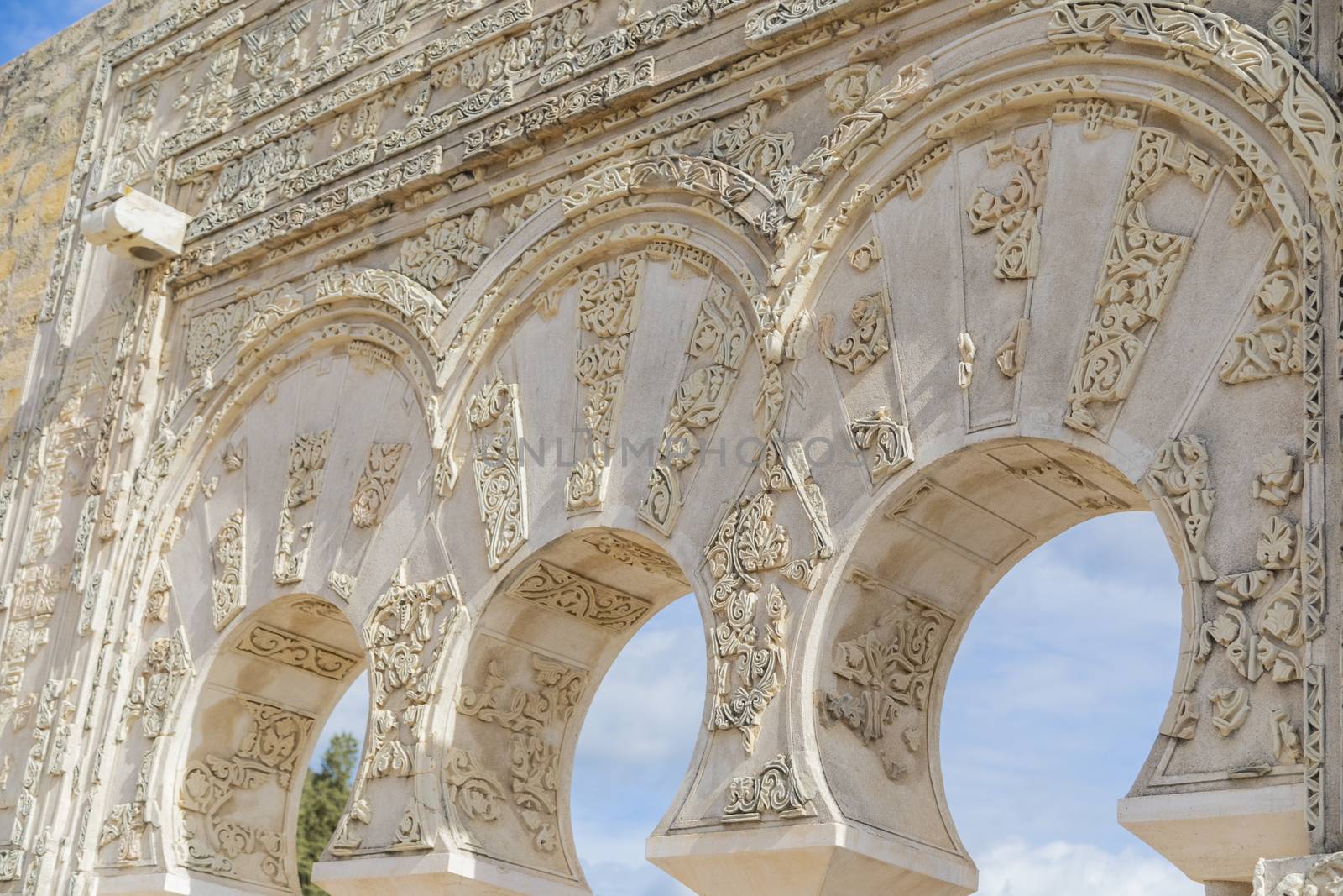 Cordoba, Spain -  November 1 2019: Fragment of wall with floral paterns in 10th century ruined Moorish medieval city Medina Azahara in Andalucia on November 1, 201. UNESCO world heritage site.