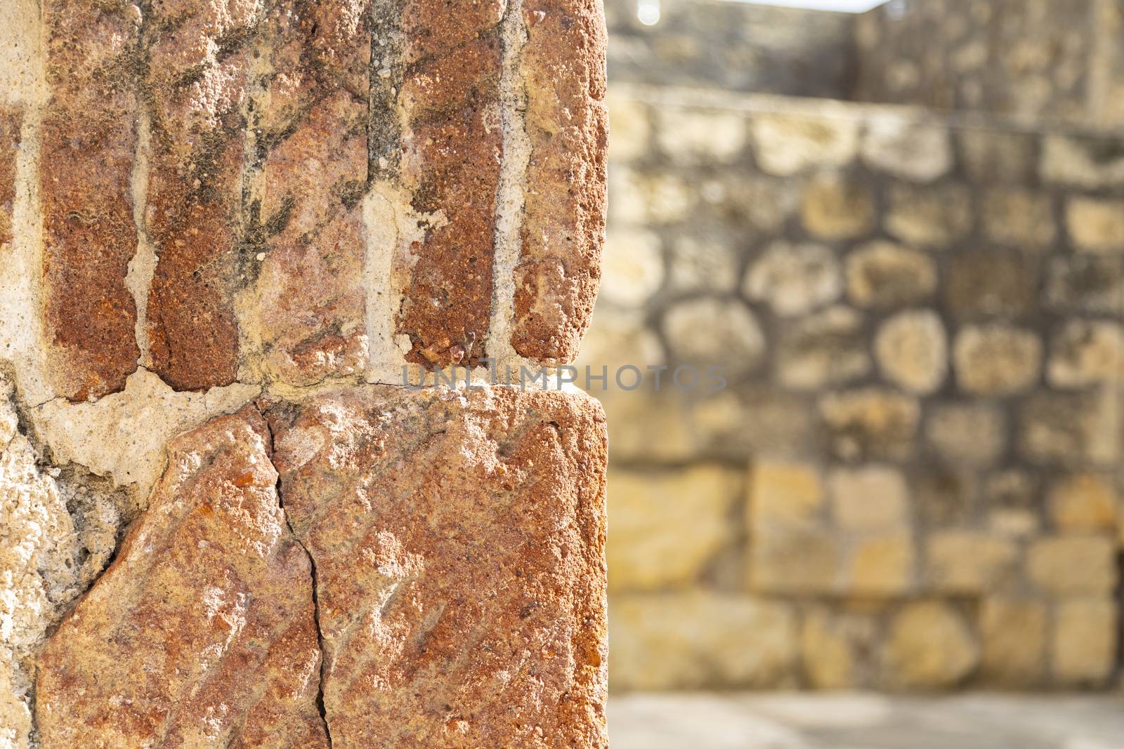 Fragment of wall with wall with stones at background.