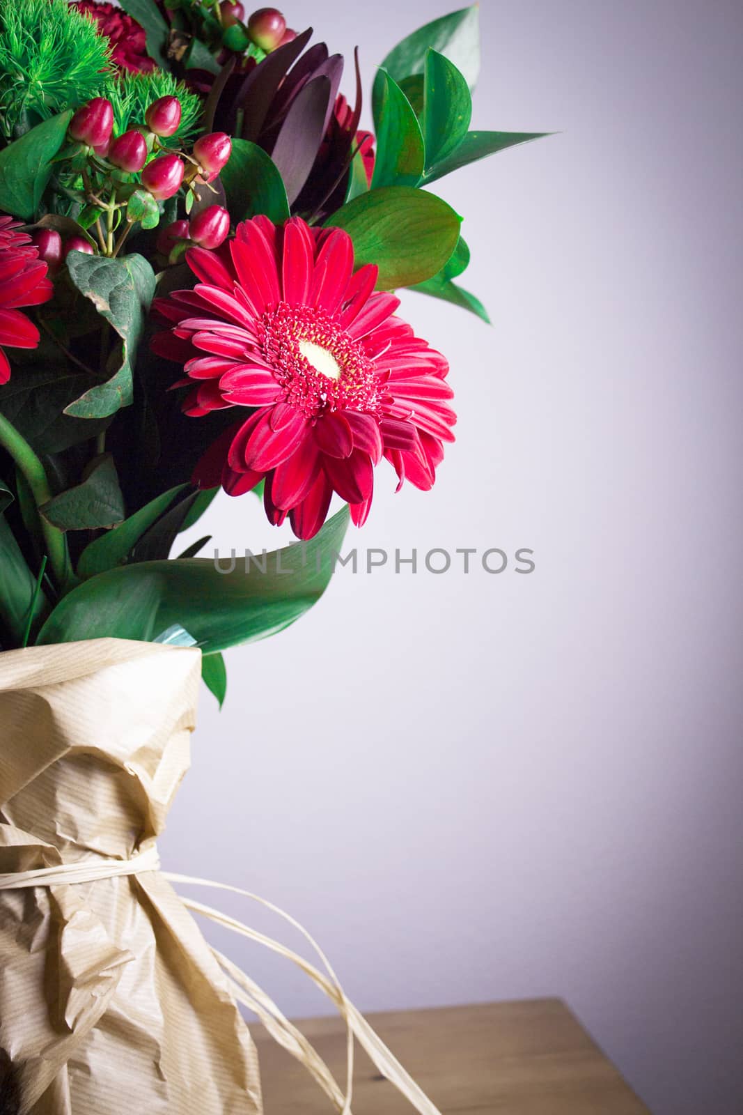 Bouquet of flowers with highlighted red daisy