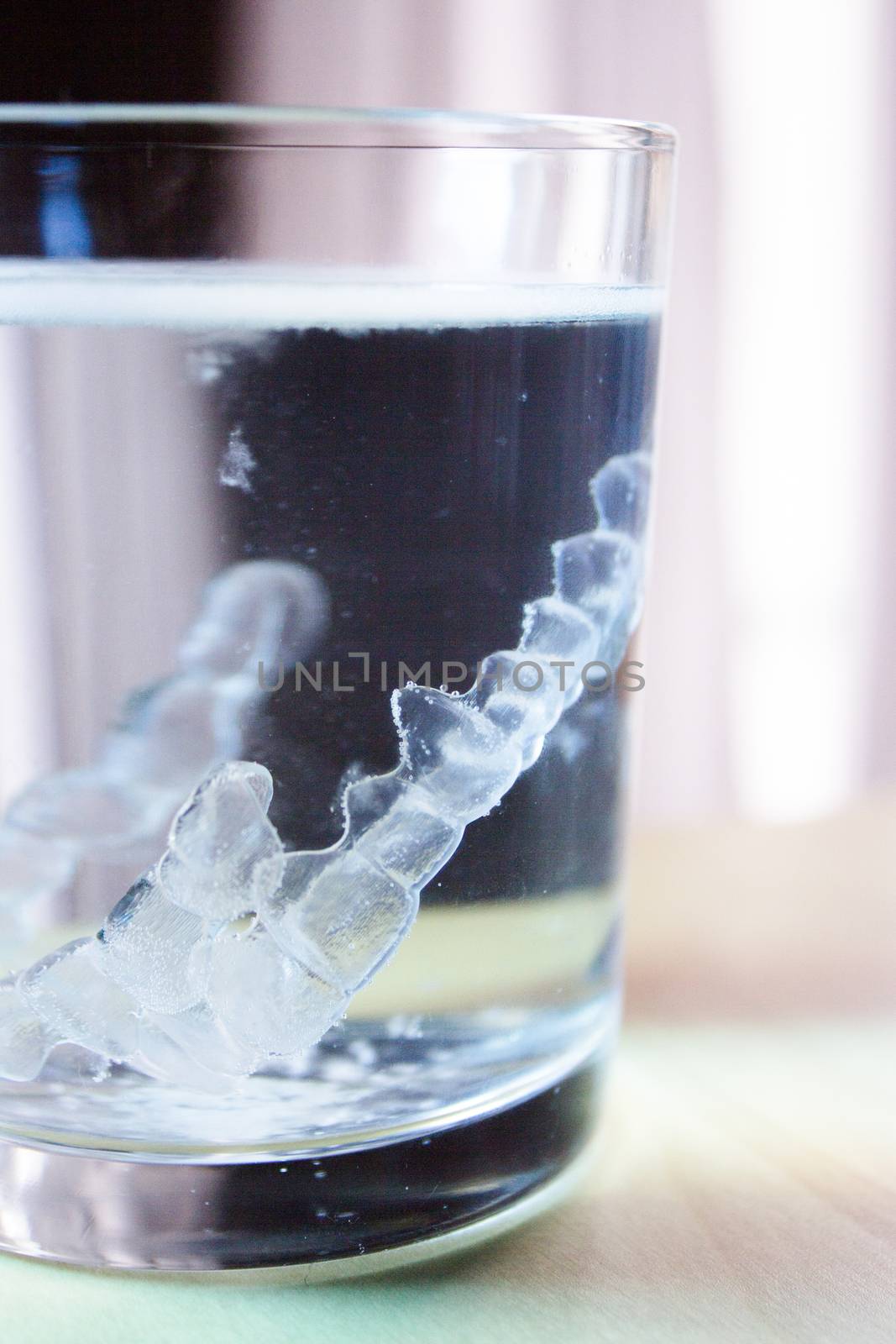 Invisible dental orthodontic submerged in water for cleaning