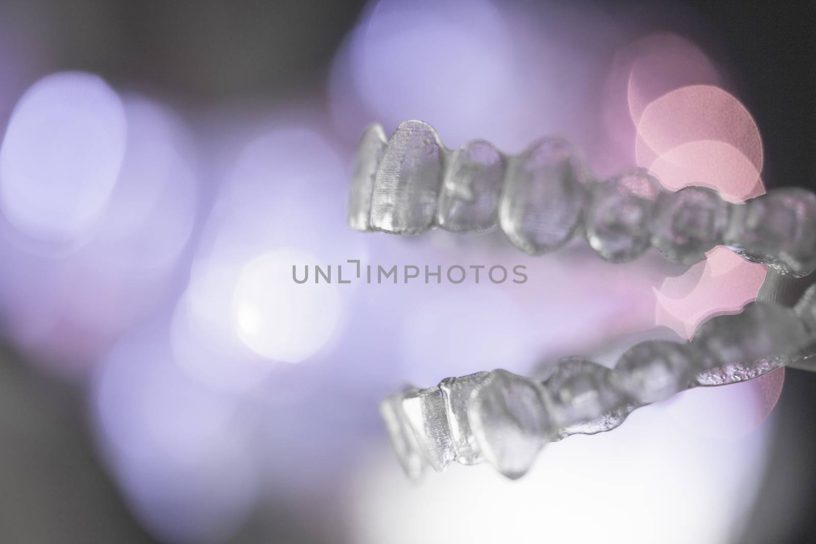 Invisible dental orthodontics on colored background by GemaIbarra
