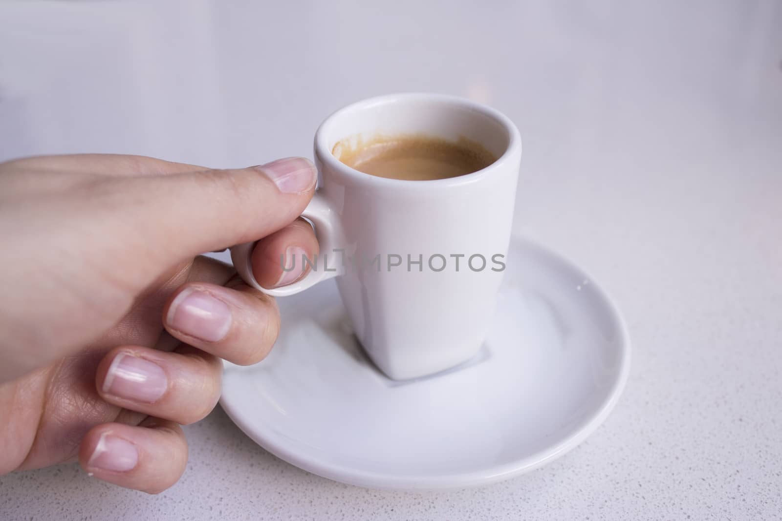 Cafeteria table with white cup of coffee