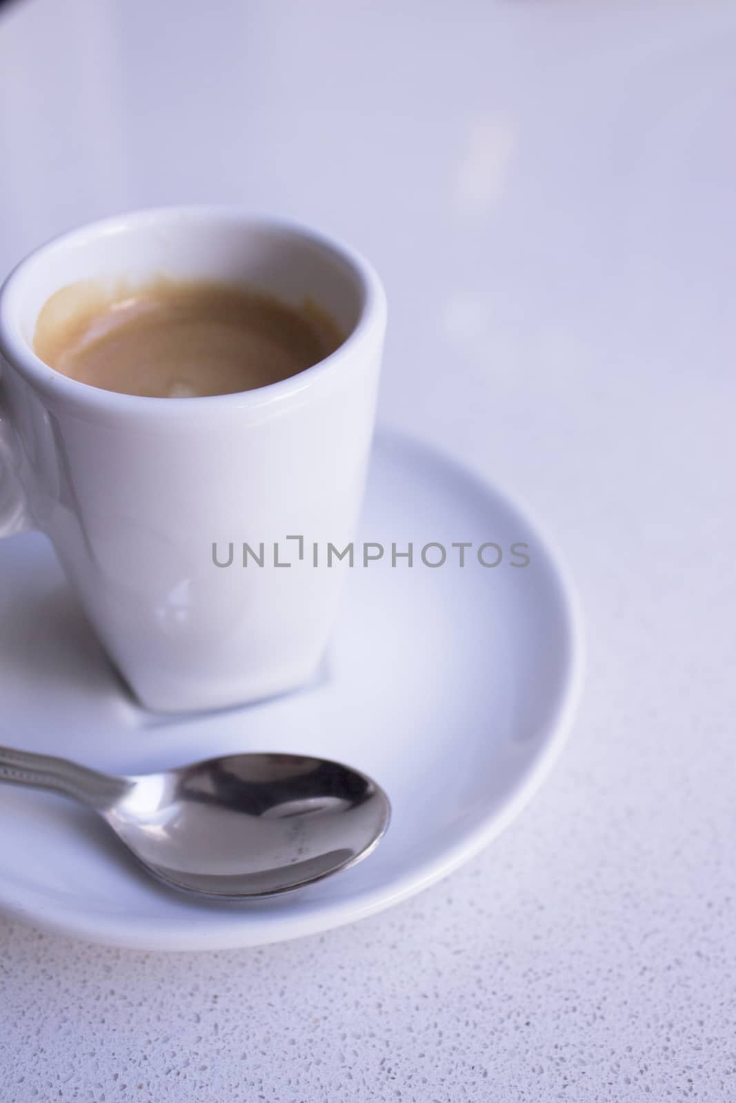 Cafeteria table with white cup of coffee