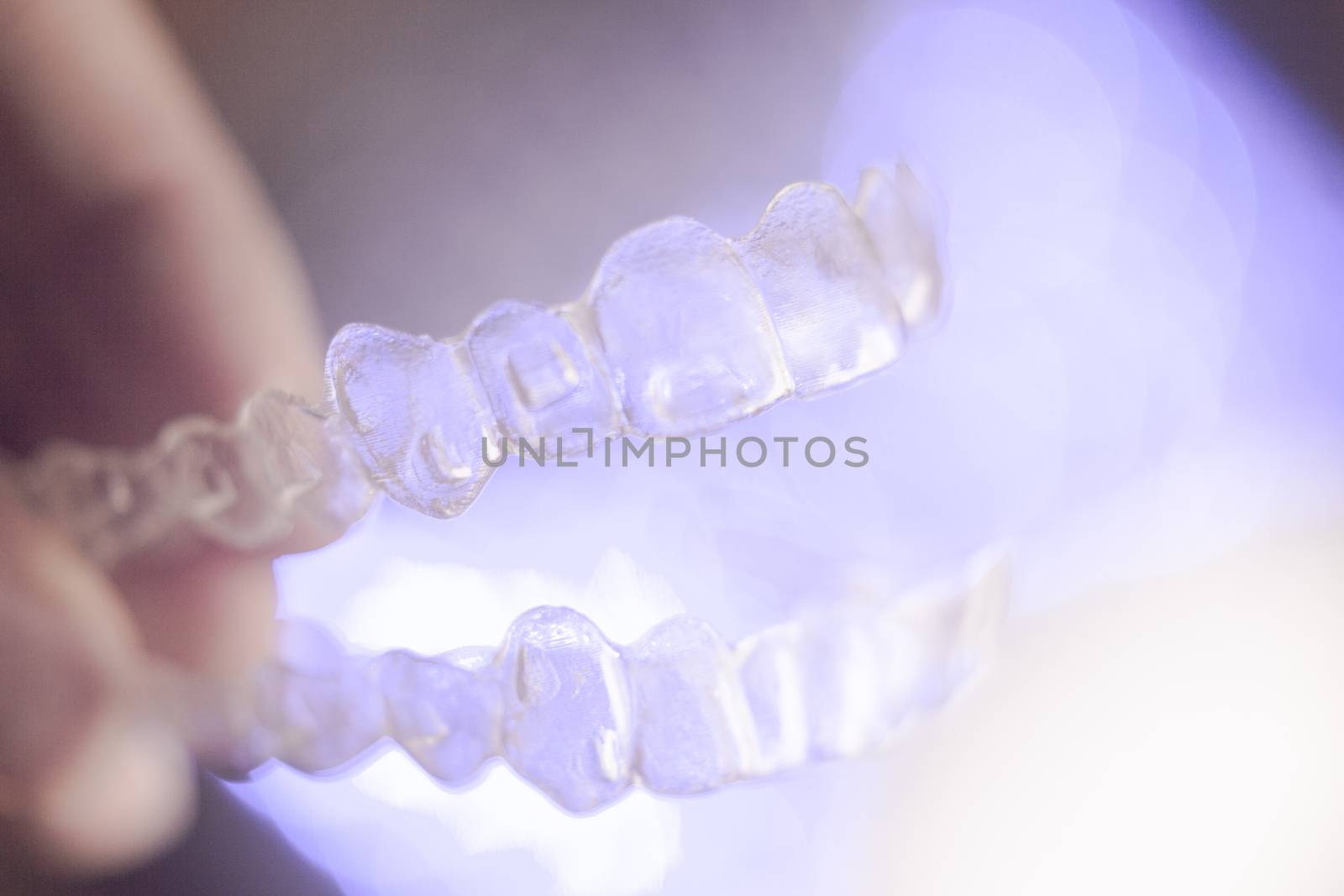Invisible dental orthodontics on colored background by GemaIbarra
