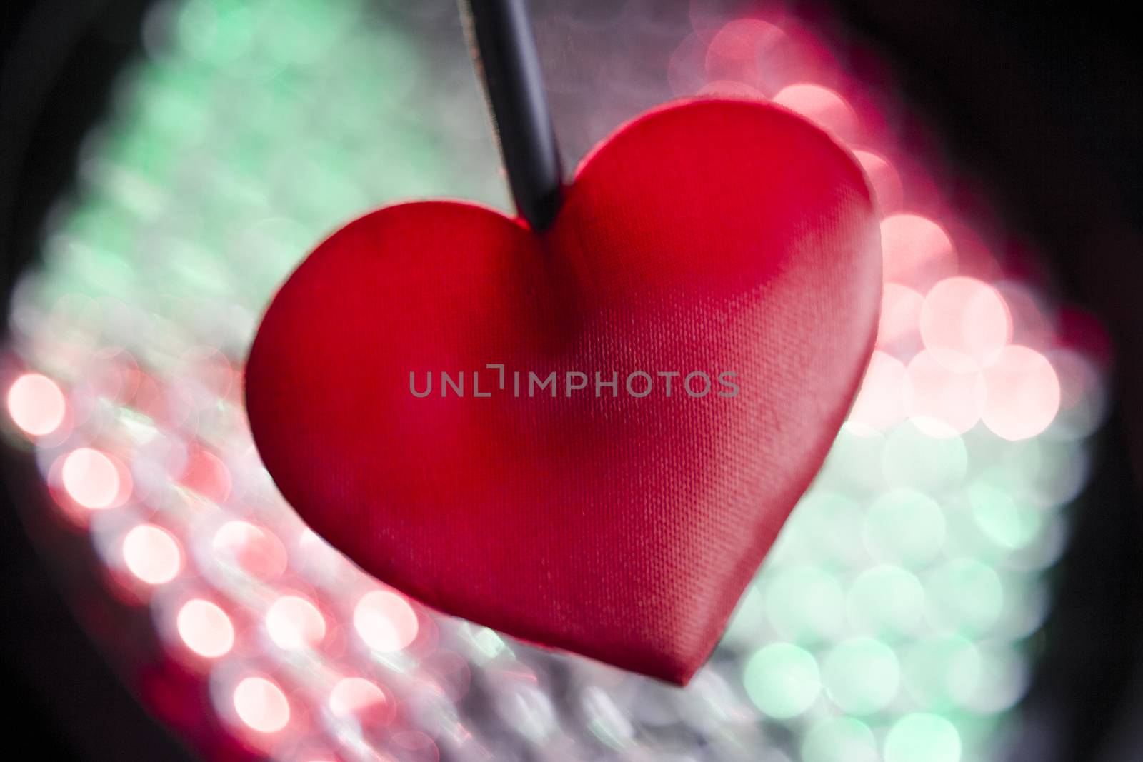 Heart on multicolored background out of focus