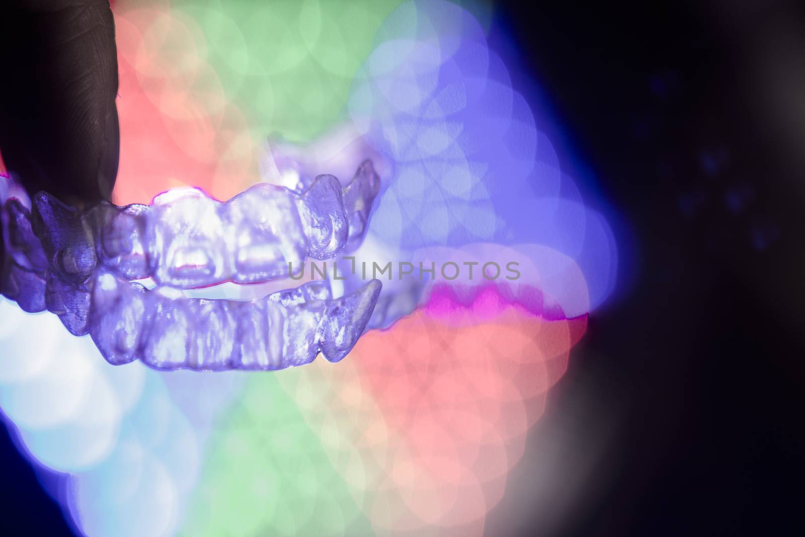 Invisible dental orthodontics on colored background