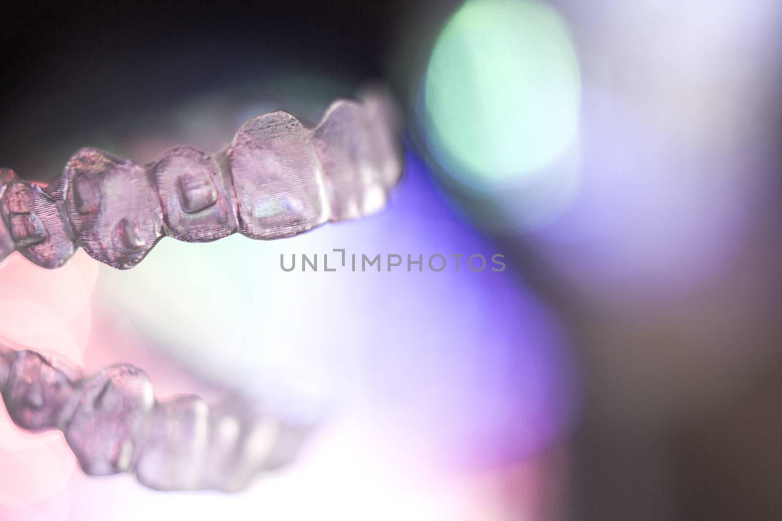 Invisible dental orthodontics on colored background by GemaIbarra