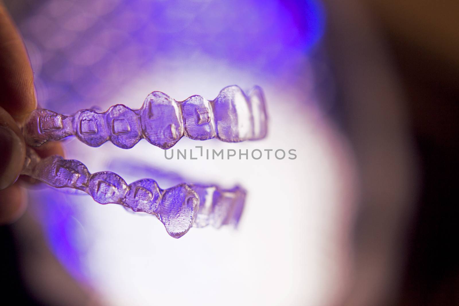 Invisible dental orthodontics on colored background