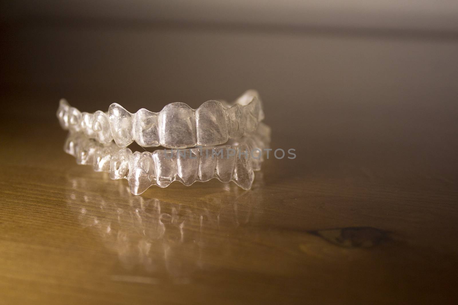 Plastic dental orthodontics on colored background. No people
