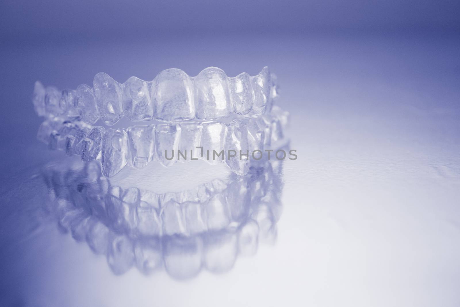 Plastic dental orthodontics on colored background. No people
