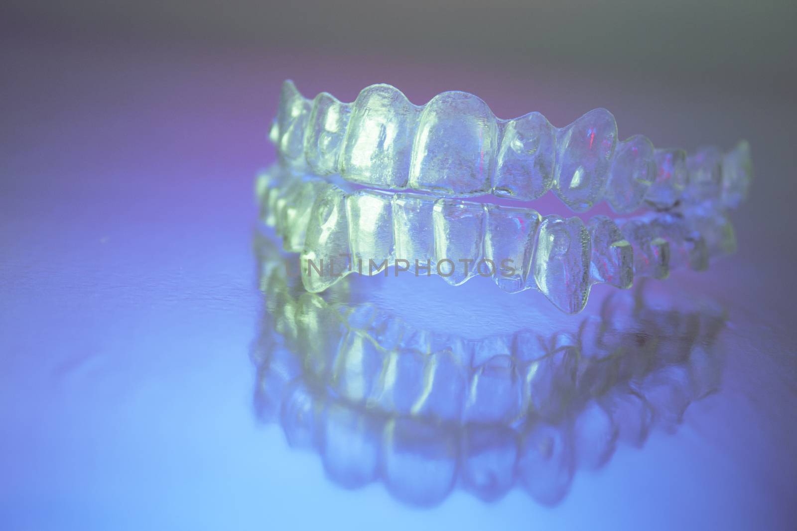 Plastic dental orthodontics on colored background. No people

