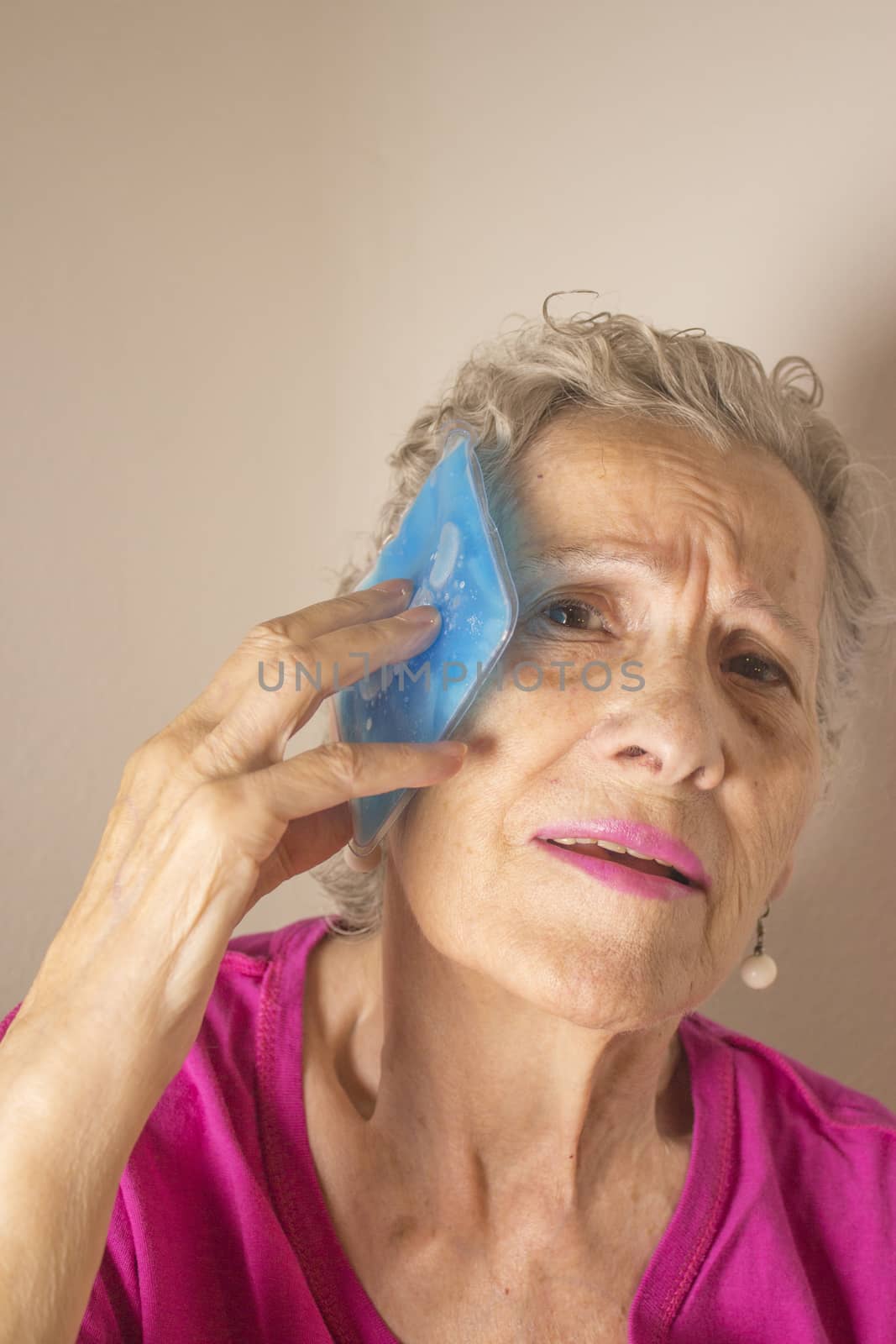 Ice pack for headache in older woman