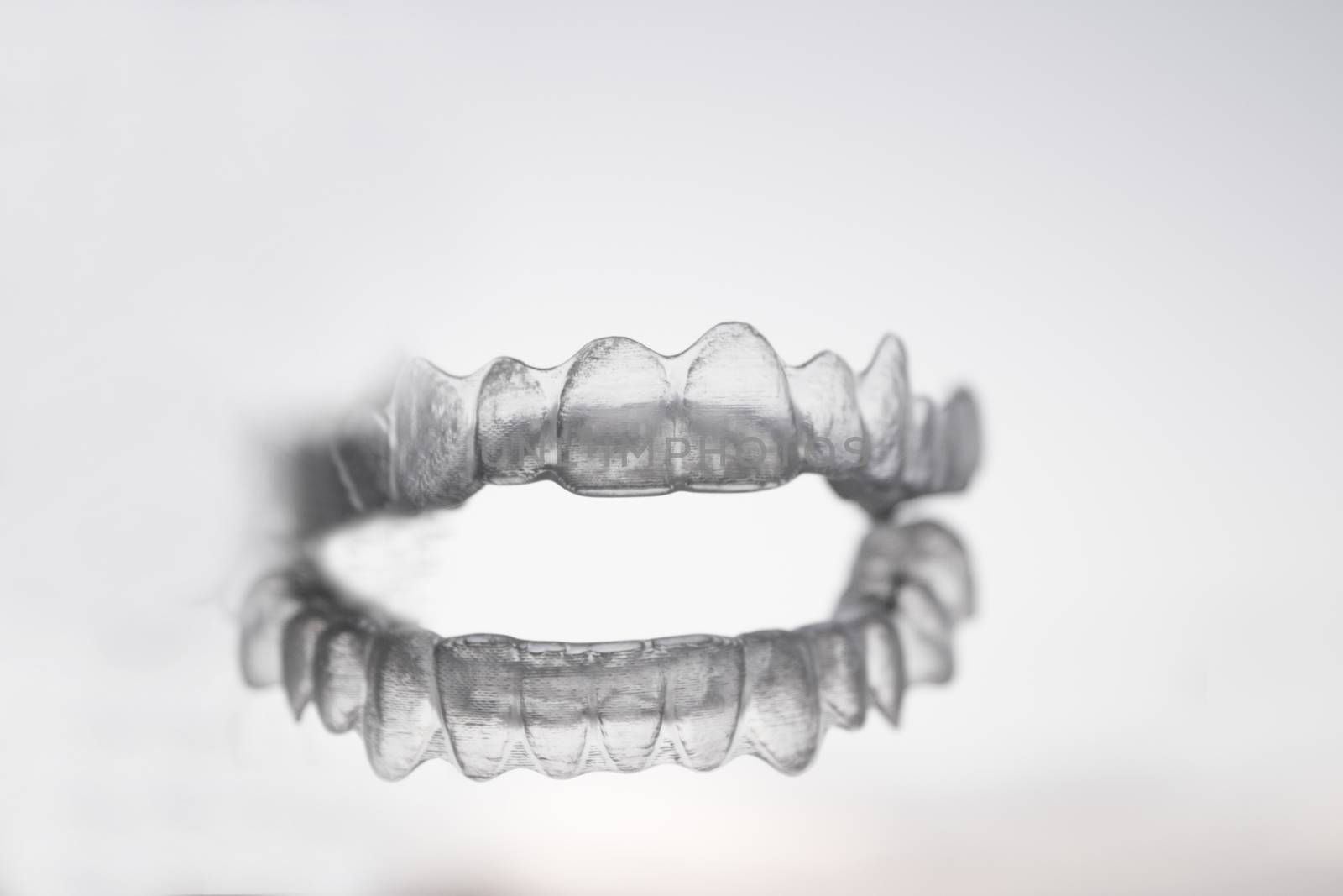 Invisible orthodontics for aligning teeth