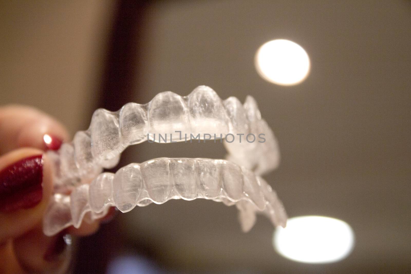 Invisible orthodontics for aligning teeth