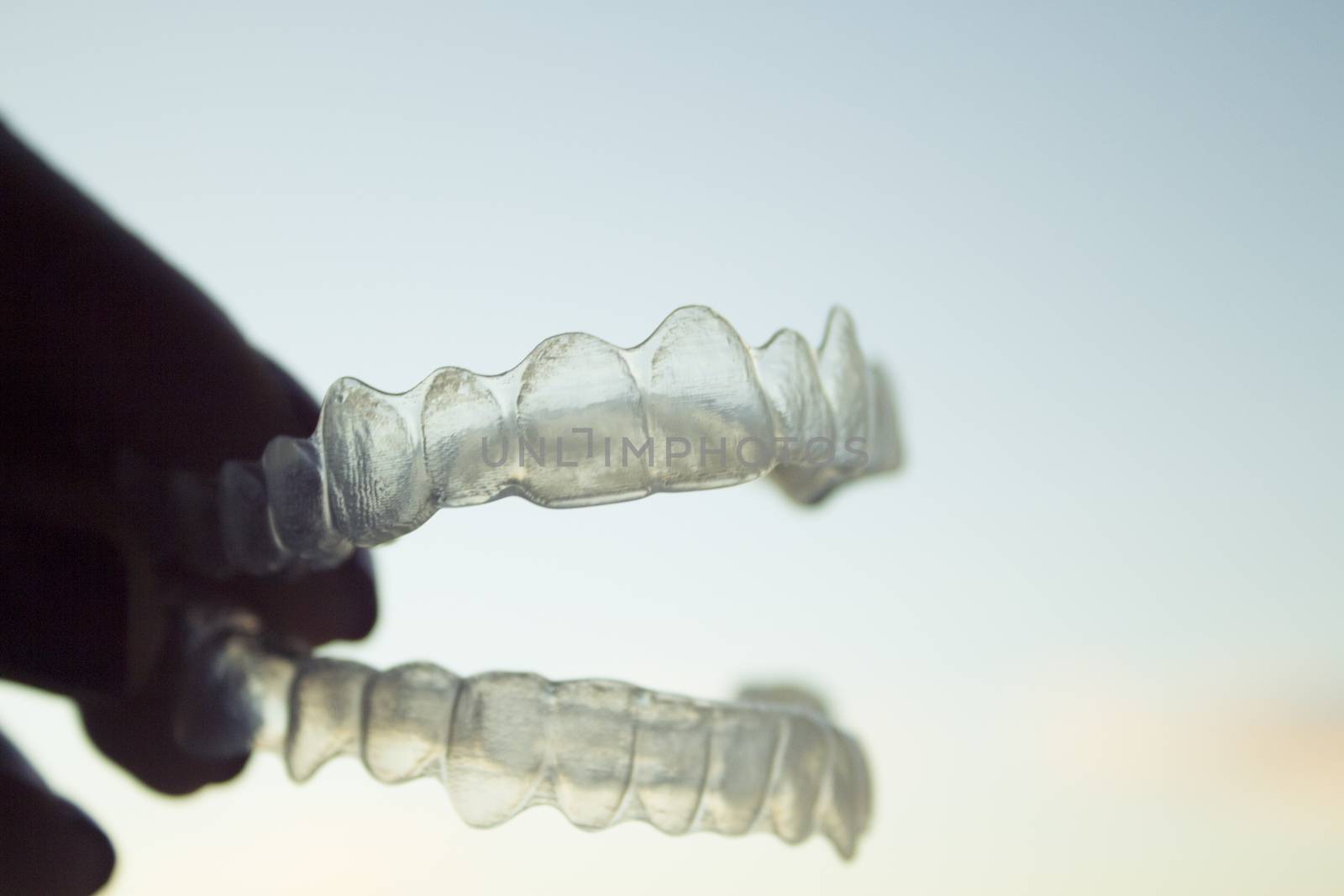 Invisible orthodontics for aligning teeth