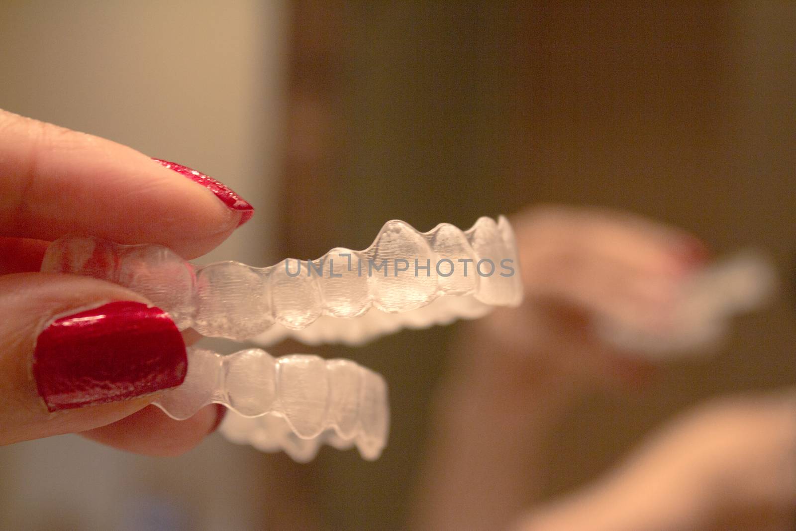 Invisible orthodontics for aligning teeth