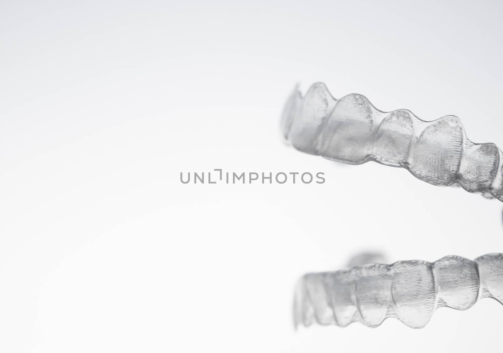 Invisible orthodontics for aligning teeth