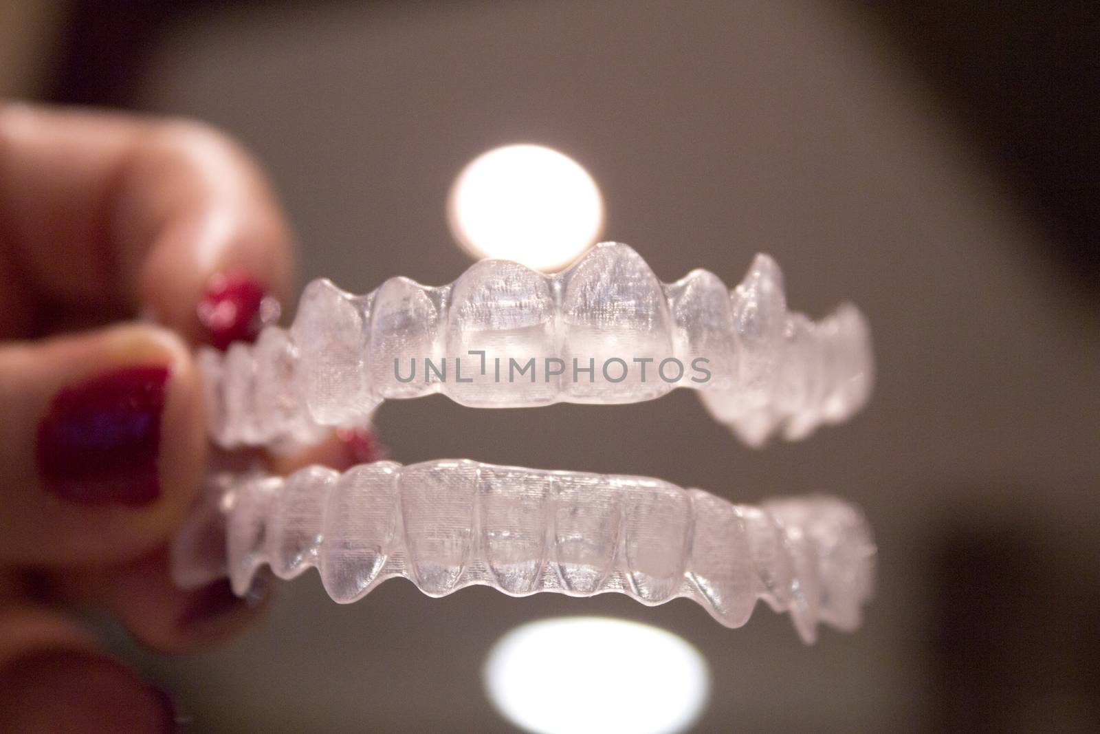 Invisible orthodontics for aligning teeth