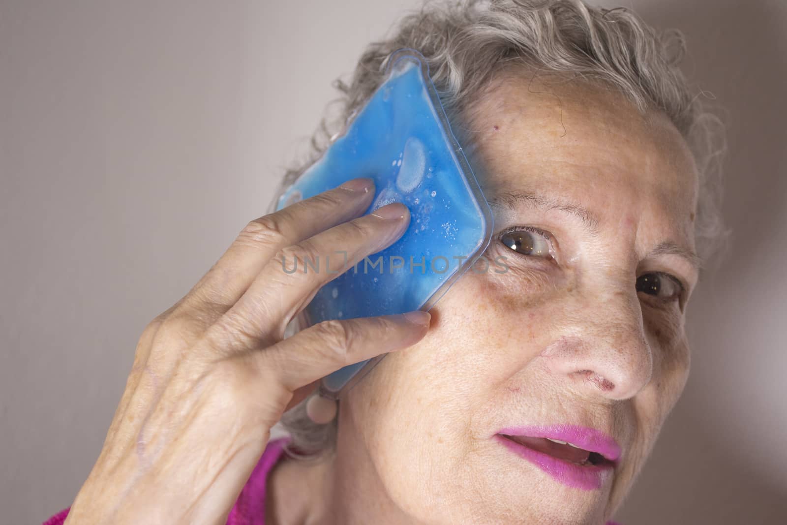 Ice pack for headache in older woman