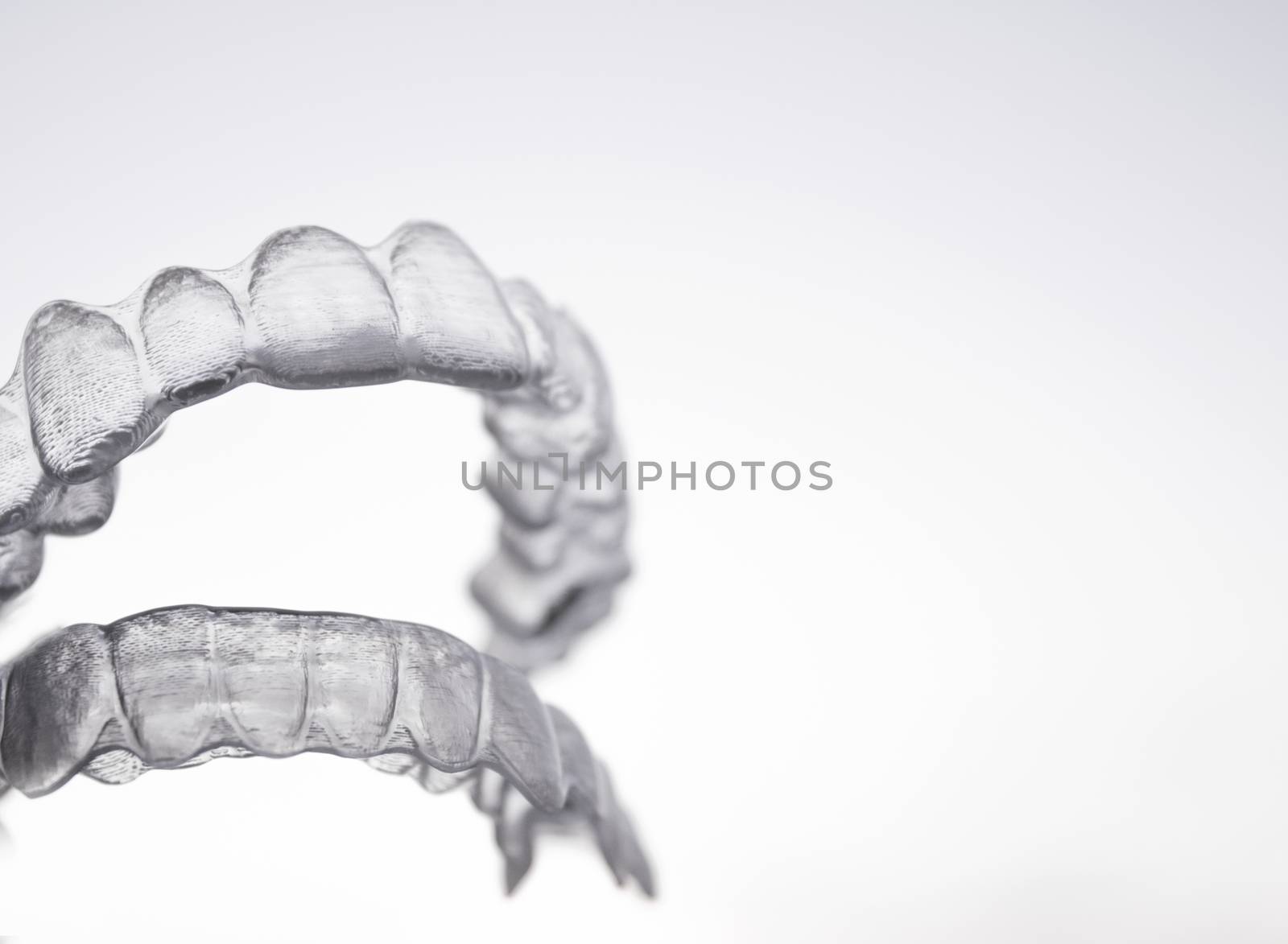 Invisible orthodontics for aligning teeth