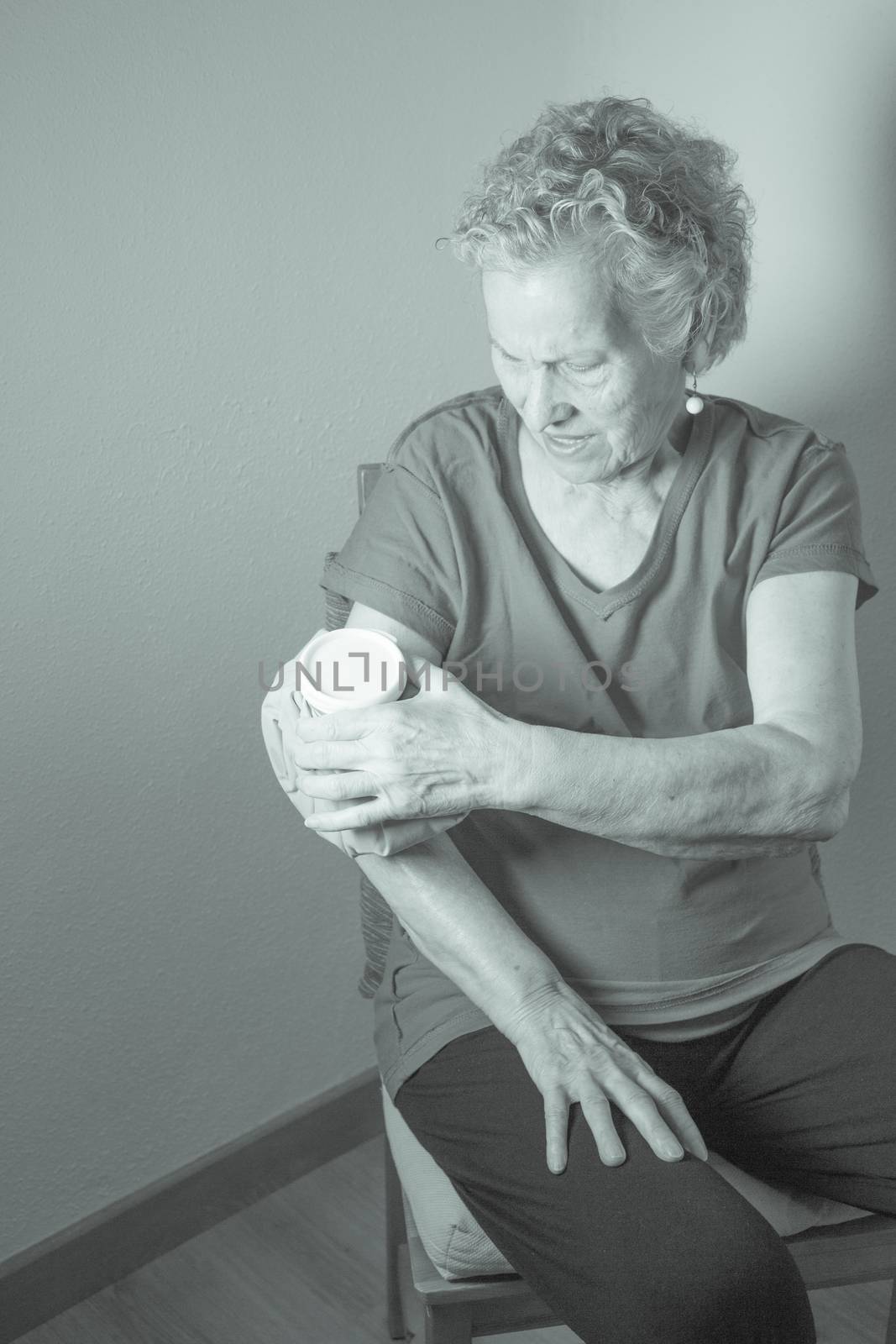 Ice pack on older woman arm to relieve pain