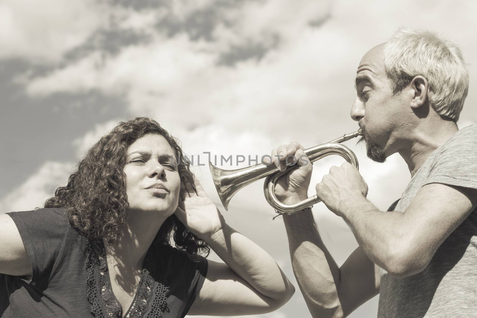 Man and woman playing trumpet by GemaIbarra