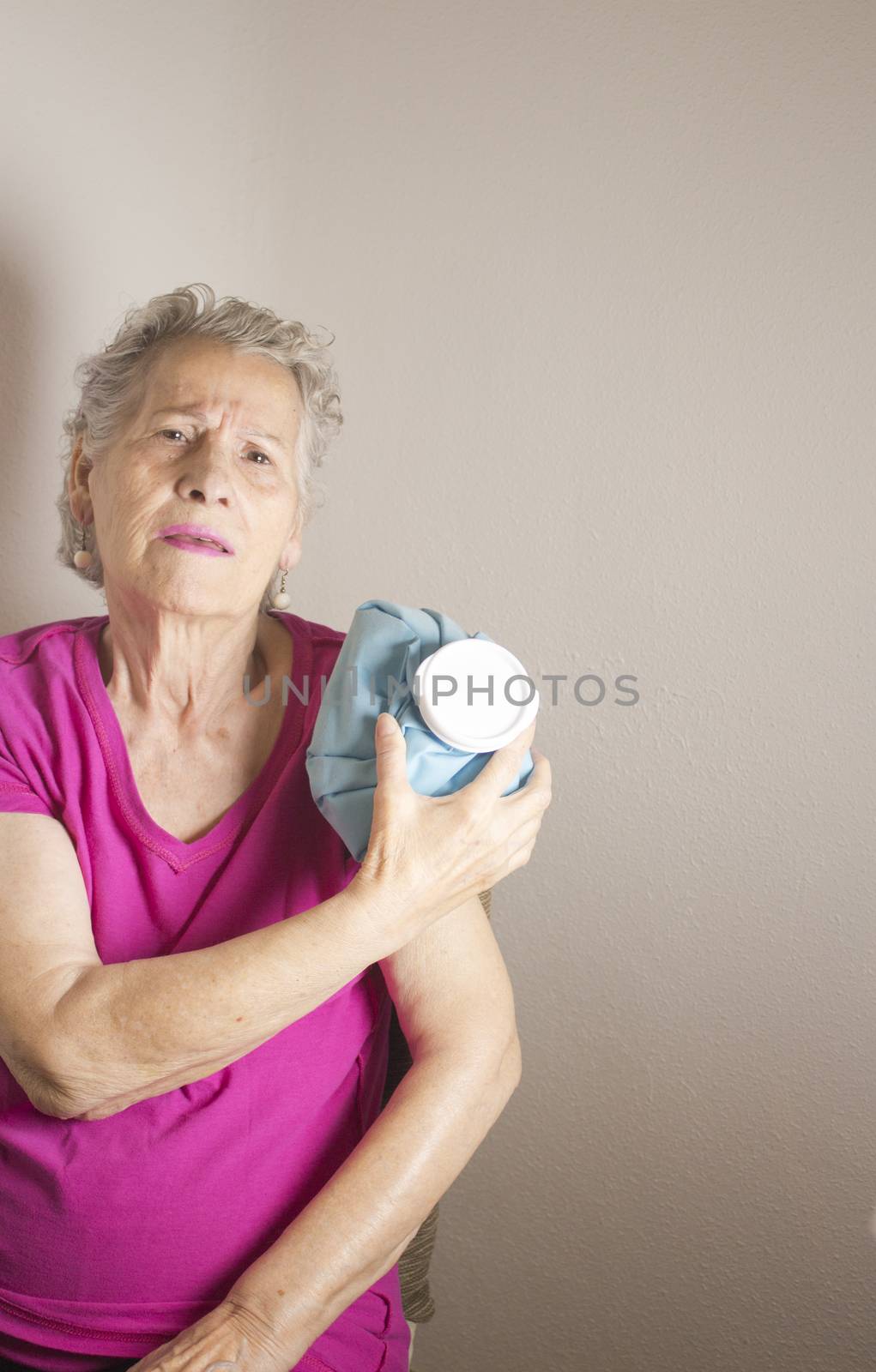 Ice pack on older woman arm to relieve pain