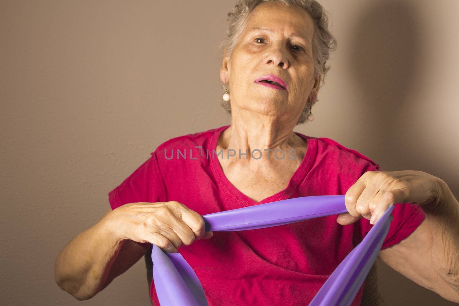 Rehabilitation exercises for older women with elastic band