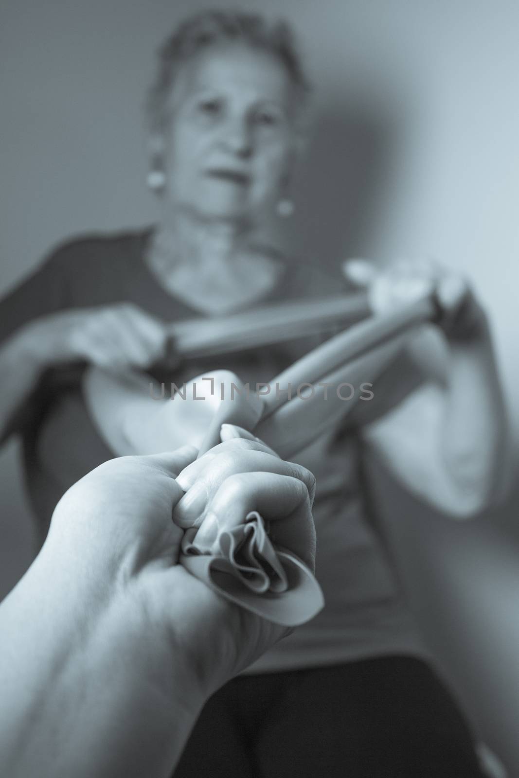 Rehabilitation exercises for older women with elastic band
