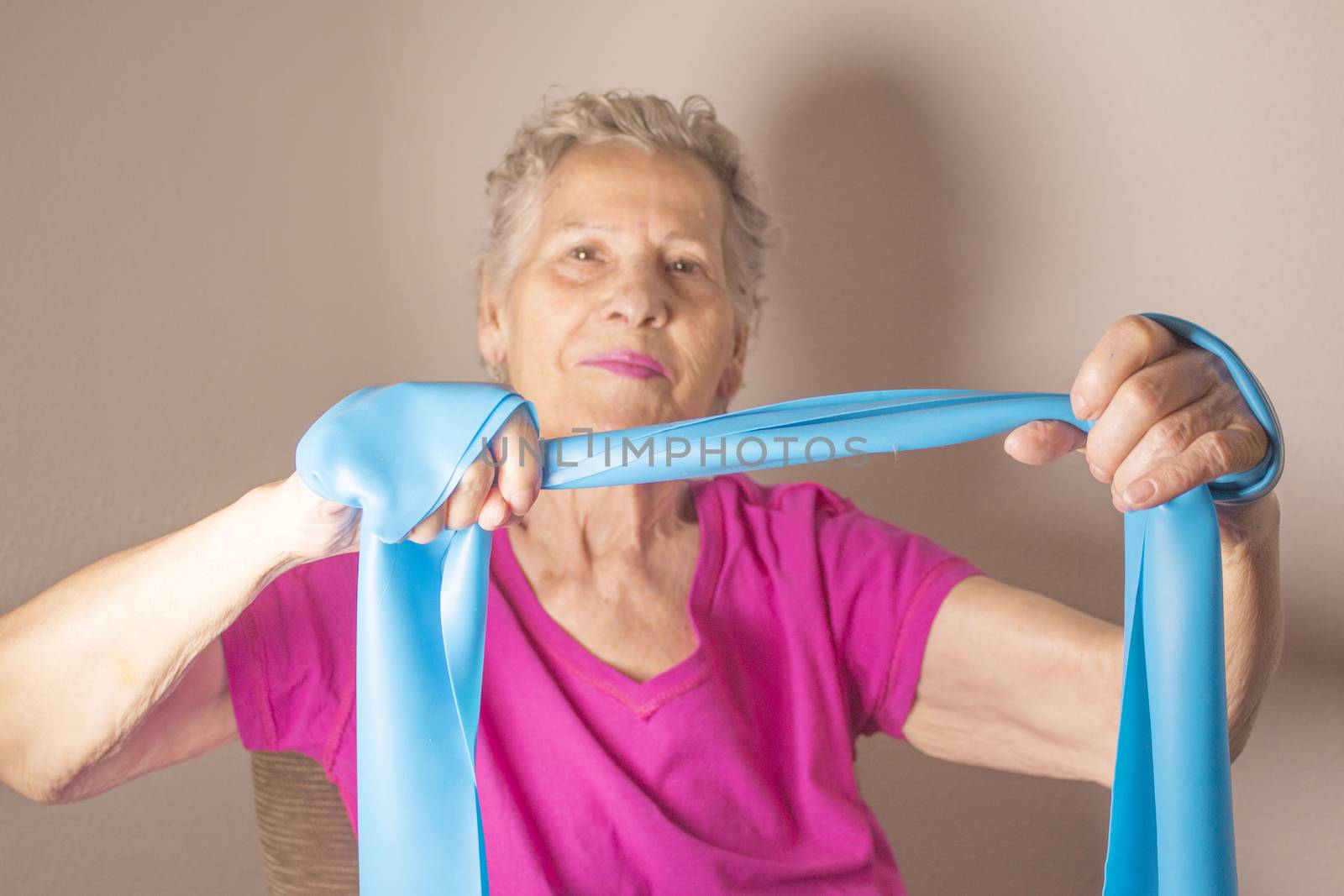 Rehabilitation exercises for older women with elastic band